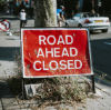 Co z Polakami w UK po Brexicie? Road ahead closed sign on the sidewalk